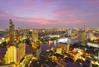 Aerial view of illuminated city at dusk