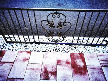 High angle view of railing on footpath