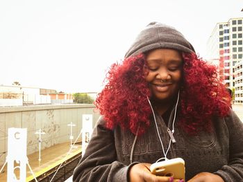 Young woman using mobile phone in city