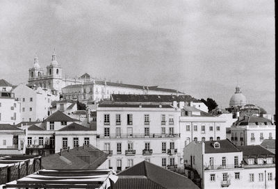 Buildings in town against sky