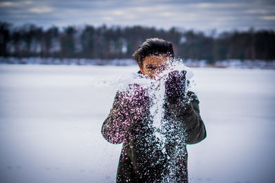 Low section of person standing on snow covered land