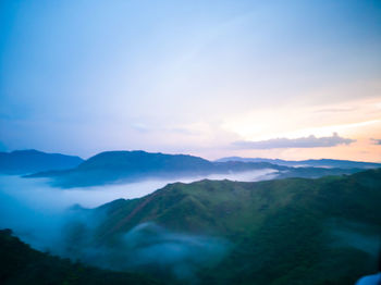 Scenic view of mountains against dramatic sky