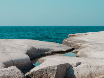 Scenic view of sea against clear blue sky