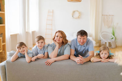 Christian big family. large family at home on sofa in living room. family