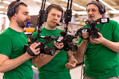 Midsection of man holding camera