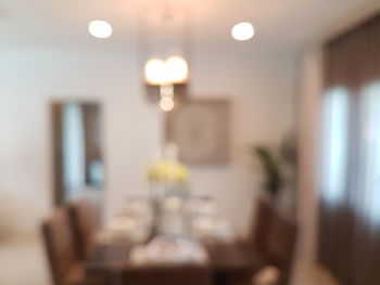 Defocused image of illuminated lights on table at home