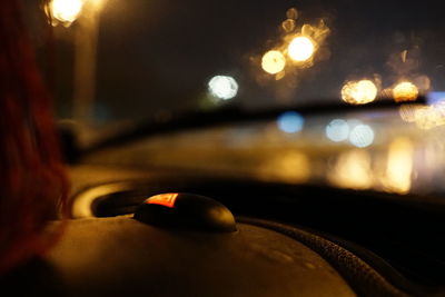 Close-up of illuminated car windshield at night