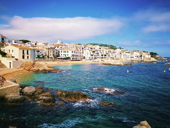 Scenic view of sea and buildings against sky