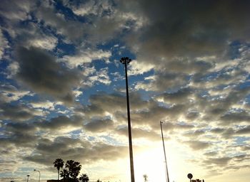 Low angle view of street light against cloudy sky