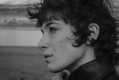 Close-up portrait of young woman looking away