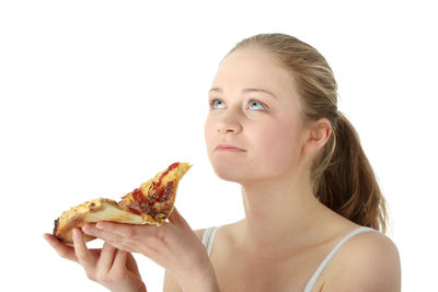 Close-up portrait of a young woman over white background