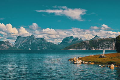 Scenic view of lake and mountains against sky