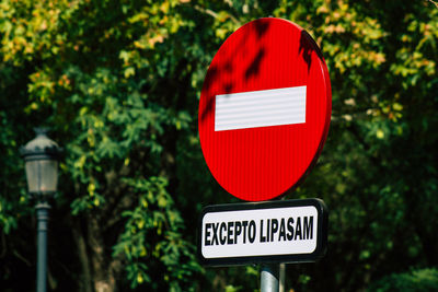 Close-up of road sign against trees