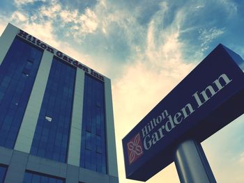 Low angle view of building against cloudy sky