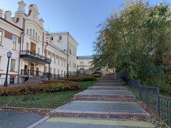 Footpath amidst buildings against sky