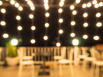 Defocused image of illuminated lights on table