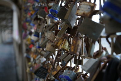 Close-up of padlocks hanging on fence