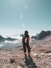 Man standing on mountain against sky