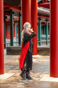 Side view of woman standing in city