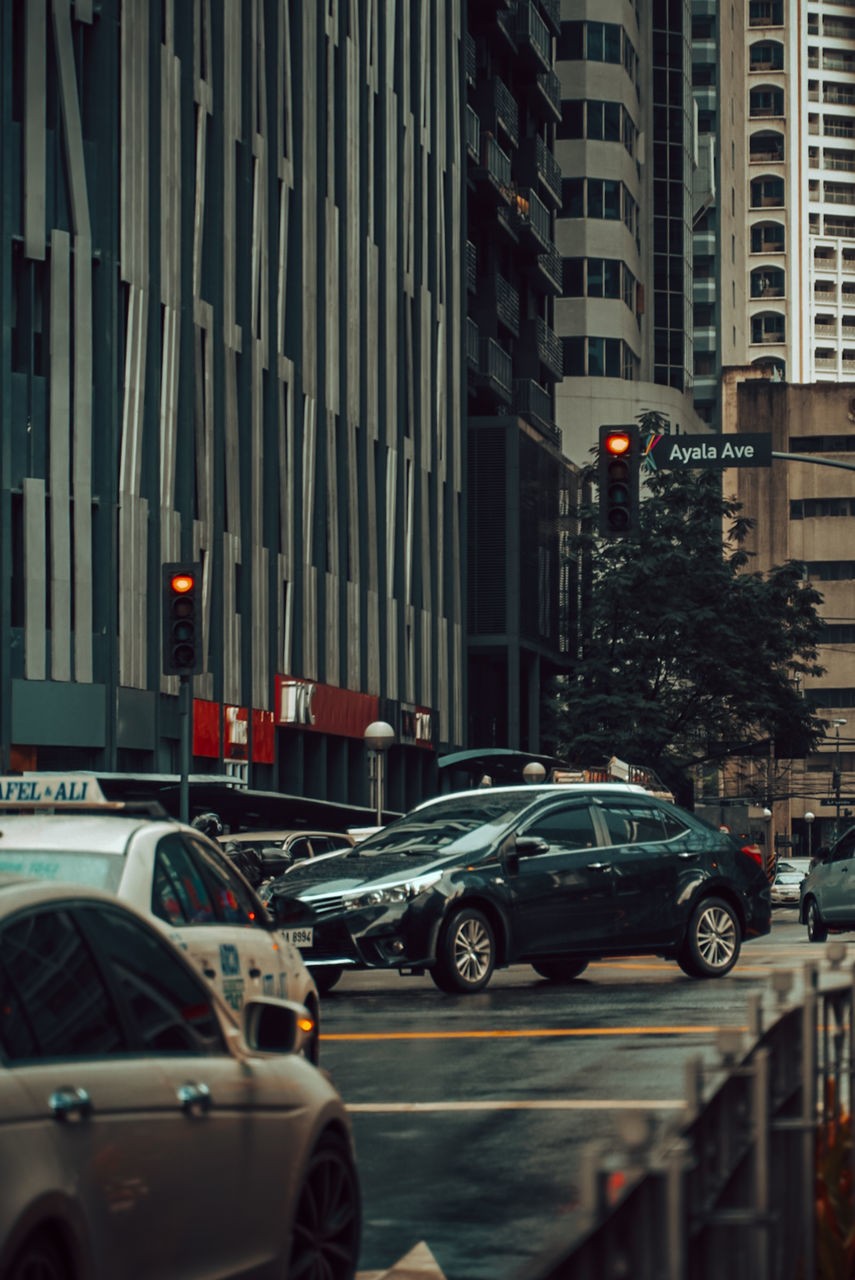 TRAFFIC ON ROAD IN CITY BUILDINGS