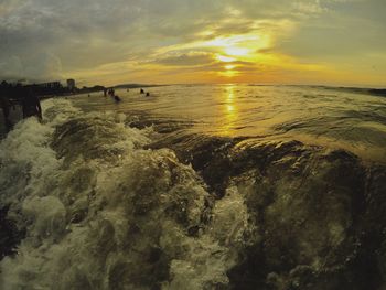 Scenic view of beach against sky during sunset