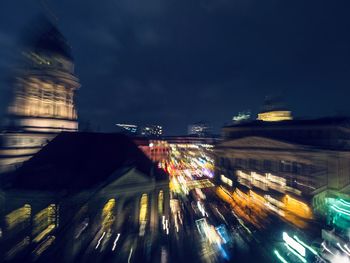 Illuminated city against sky at night