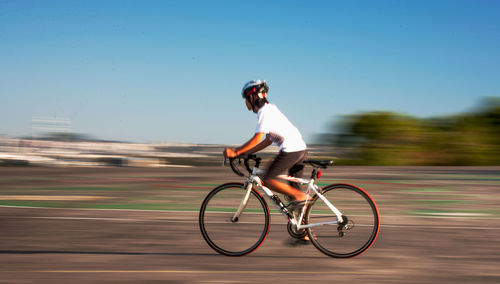 Man riding bicycle on road