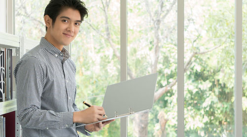 Portrait of young man using mobile phone