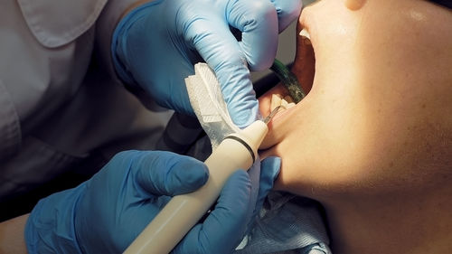 Cropped image of dentist examining patient