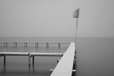 Pier over sea against clear sky