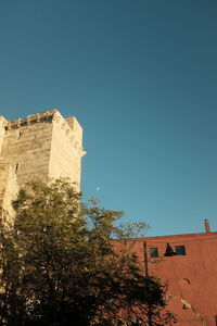 Low angle view of building against clear blue sky