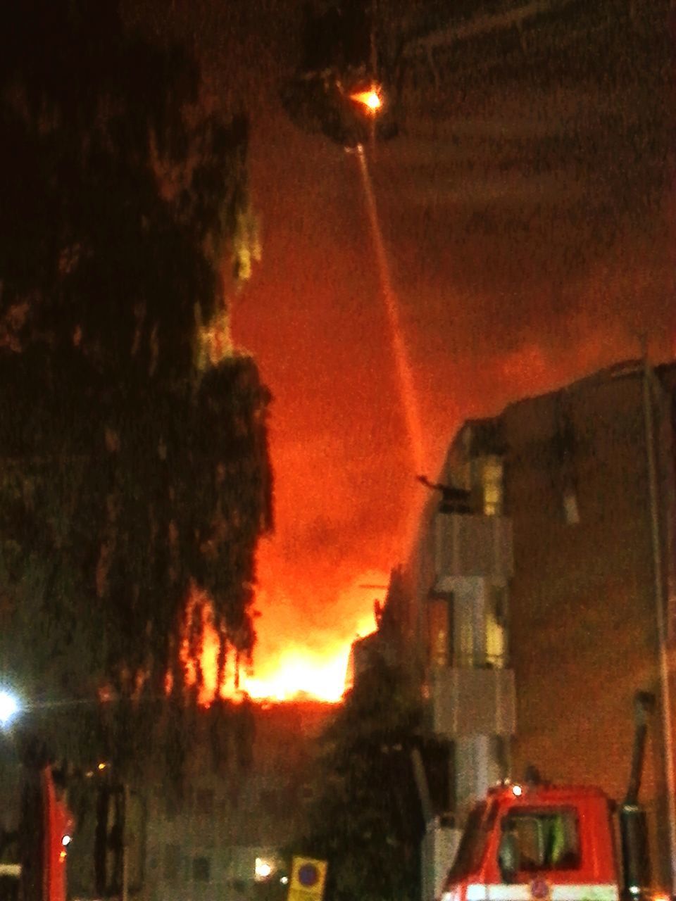 VIEW OF ILLUMINATED STREET LIGHTS AT NIGHT