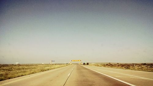 Empty road along trees