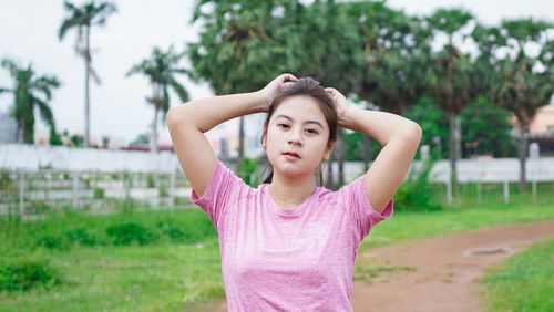 Portrait of teenage girl standing on field