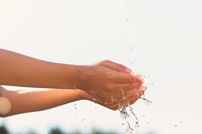 Water falling cropped hands