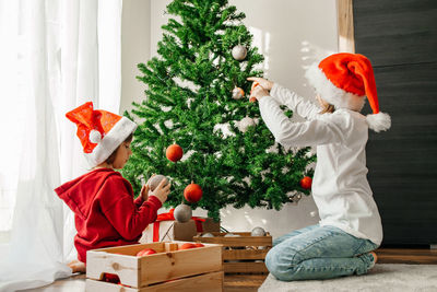 Rear view of man holding christmas presents