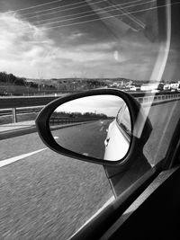 Reflection on side-view mirror of car