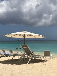 Lifeguard hut on beach against sky