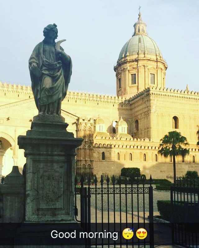 architecture, building exterior, built structure, text, western script, low angle view, human representation, city, clear sky, communication, travel destinations, famous place, sky, travel, non-western script, statue, capital cities, tourism, international landmark