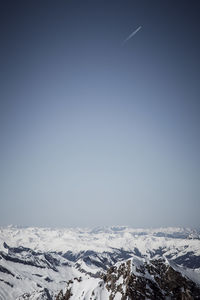 Scenic view of snowcapped mountains against clear sky