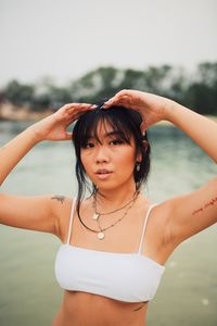 Portrait of woman standing in sea