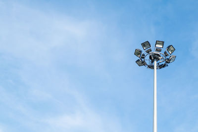 Low angle view of floodlight against blue sky