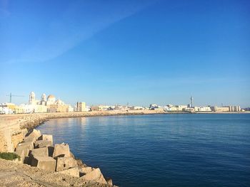 Scenic view of sea against clear blue sky