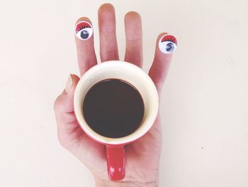 Close-up high angle view of hand holding black tea