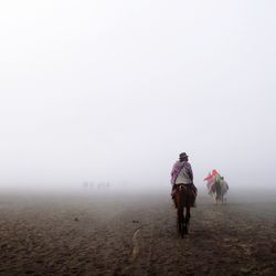 Man standing in foggy weather