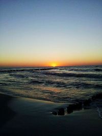 Scenic view of sea against clear sky during sunset