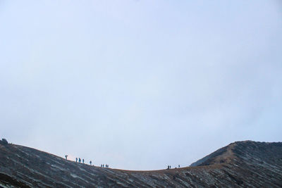 Low angle view of land against clear sky