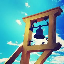 Low angle view of bell tower against blue sky