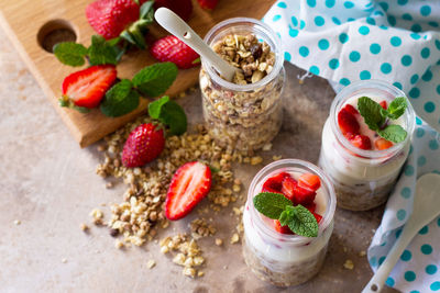 Homemade healthy breakfast with homemade baked granola, fresh strawberry and yogurt. 