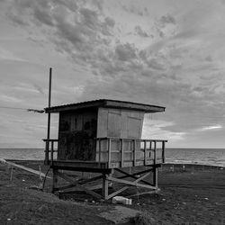 Built structure on beach against sky